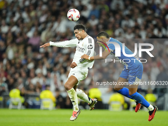 Jude Bellingham central midfield of Real Madrid and England and Santiago Mouriño centre-back of Alaves and Uruguay compete for the ball duri...