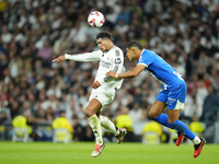 Jude Bellingham central midfield of Real Madrid and England and Santiago Mouriño centre-back of Alaves and Uruguay compete for the ball duri...