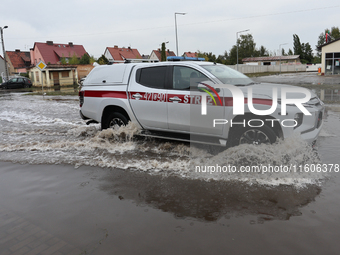 Fire fighter car is seen at flooded street in Lewin Brzeski, Poland on September 23, 2024. (