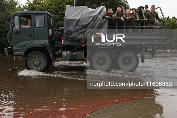 Army vehicle is seen at the flooded street in Lewin Brzeski, Poland on September 23, 2024. 