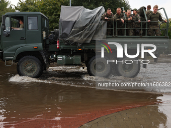 Army vehicle is seen at the flooded street in Lewin Brzeski, Poland on September 23, 2024. (