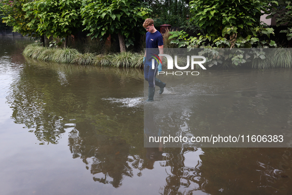 A person walks the flooded street in Lewin Brzeski, Poland on September 23, 2024. 