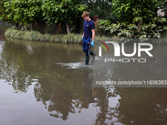 A person walks the flooded street in Lewin Brzeski, Poland on September 23, 2024. (