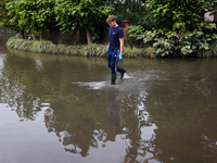 A person walks the flooded street in Lewin Brzeski, Poland on September 23, 2024. (