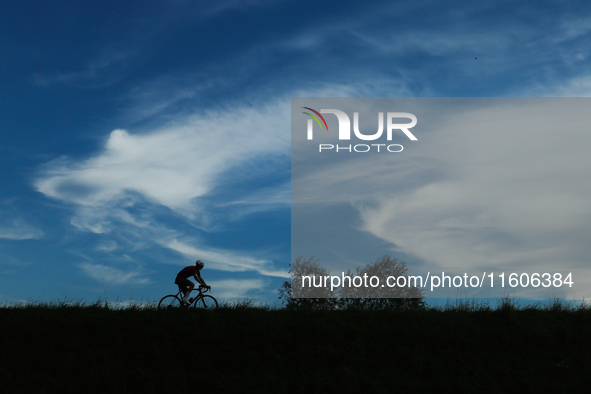 A Cyclist rides the flood embankment in Krakow, Poland on September 23, 2024. 