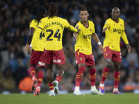 Tom Ince #7 of Watford F.C. celebrates his goal with teammates during the Carabao Cup Third Round match between Manchester City and Watford...