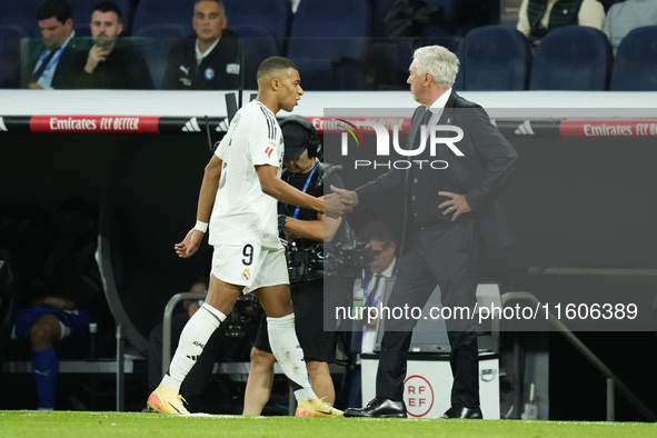 Kylian Mbappe centre-forward of Real Madrid and France greets to Carlo Ancelotti head coach of Real Madrid after replaced during the La Liga...