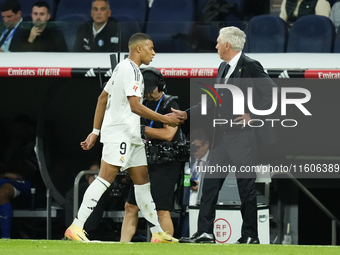 Kylian Mbappe centre-forward of Real Madrid and France greets to Carlo Ancelotti head coach of Real Madrid after replaced during the La Liga...