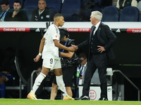 Kylian Mbappe centre-forward of Real Madrid and France greets to Carlo Ancelotti head coach of Real Madrid after replaced during the La Liga...