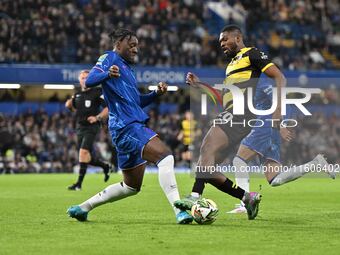 Emile Acquah (20 Barrow) is challenged by Axel Disasi (2 Chelsea) during the Carabao Cup Third Round match between Chelsea and Barrow at Sta...