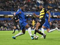 Emile Acquah (20 Barrow) is challenged by Axel Disasi (2 Chelsea) during the Carabao Cup Third Round match between Chelsea and Barrow at Sta...