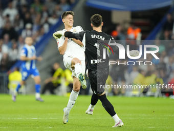 Arda Guler attacking midfield of Real Madrid and Turkey and Antonio Sivera goalkeeper of Alaves and Spain compete for the ball during the La...