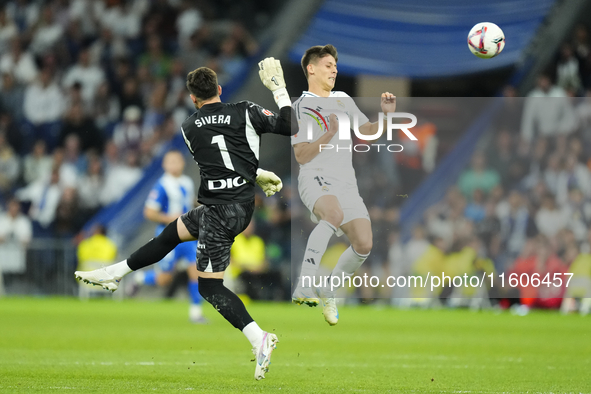 Arda Guler attacking midfield of Real Madrid and Turkey and Antonio Sivera goalkeeper of Alaves and Spain compete for the ball during the La...