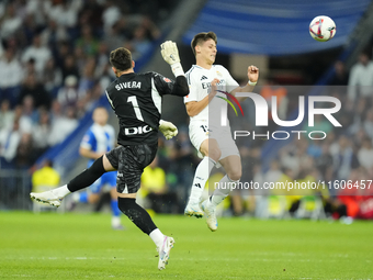 Arda Guler attacking midfield of Real Madrid and Turkey and Antonio Sivera goalkeeper of Alaves and Spain compete for the ball during the La...