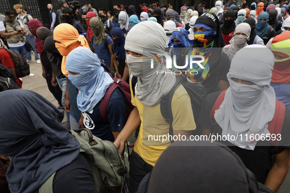 The 43 missing students from Ayotzinapa throw firecrackers on Tuesday, September 24, 2024, and demonstrate outside the Senate of the Republi...