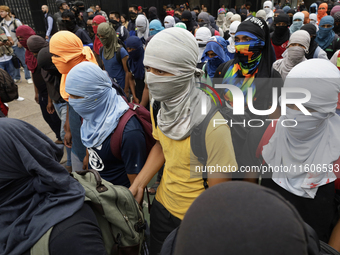 The 43 missing students from Ayotzinapa throw firecrackers on Tuesday, September 24, 2024, and demonstrate outside the Senate of the Republi...