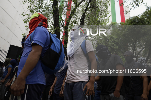 The 43 missing students from Ayotzinapa throw firecrackers on Tuesday, September 24, 2024, and demonstrate outside the Senate of the Republi...