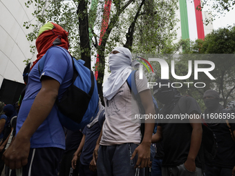 The 43 missing students from Ayotzinapa throw firecrackers on Tuesday, September 24, 2024, and demonstrate outside the Senate of the Republi...