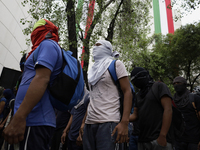 The 43 missing students from Ayotzinapa throw firecrackers on Tuesday, September 24, 2024, and demonstrate outside the Senate of the Republi...