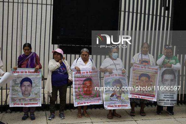 Mothers and fathers of the 43 missing students from Ayotzinapa and their companions demonstrate outside the Senate of the Republic in Mexico...