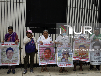 Mothers and fathers of the 43 missing students from Ayotzinapa and their companions demonstrate outside the Senate of the Republic in Mexico...