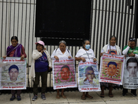 Mothers and fathers of the 43 missing students from Ayotzinapa and their companions demonstrate outside the Senate of the Republic in Mexico...