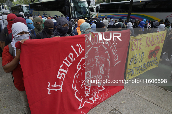 The 43 missing students from Ayotzinapa throw firecrackers on Tuesday, September 24, 2024, and demonstrate outside the Senate of the Republi...