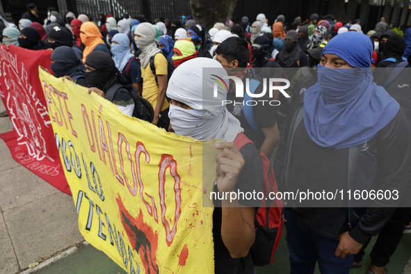 The 43 missing students from Ayotzinapa throw firecrackers on Tuesday, September 24, 2024, and demonstrate outside the Senate of the Republi...