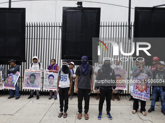 Mothers and fathers of the 43 missing students from Ayotzinapa and their companions demonstrate outside the Senate of the Republic in Mexico...