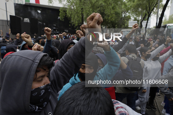 The 43 missing students from Ayotzinapa throw firecrackers on Tuesday, September 24, 2024, and demonstrate outside the Senate of the Republi...