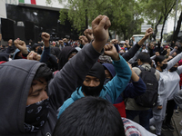 The 43 missing students from Ayotzinapa throw firecrackers on Tuesday, September 24, 2024, and demonstrate outside the Senate of the Republi...