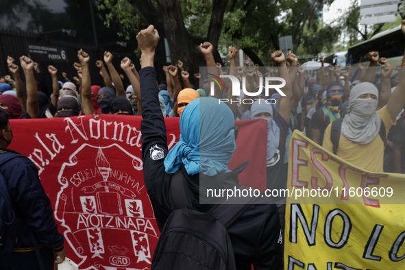 The 43 missing students from Ayotzinapa throw firecrackers on Tuesday, September 24, 2024, and demonstrate outside the Senate of the Republi...