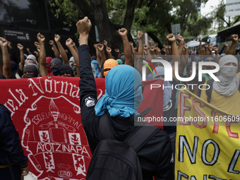 The 43 missing students from Ayotzinapa throw firecrackers on Tuesday, September 24, 2024, and demonstrate outside the Senate of the Republi...