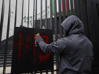 The 43 missing students of Ayotzinapa paint graffiti outside the Senate of the Republic in Mexico City, Mexico, on September 24, 2024, to de...