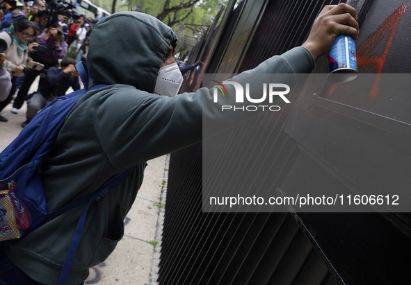 The 43 missing students of Ayotzinapa paint graffiti outside the Senate of the Republic in Mexico City, Mexico, on September 24, 2024, to de...