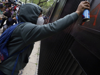 The 43 missing students of Ayotzinapa paint graffiti outside the Senate of the Republic in Mexico City, Mexico, on September 24, 2024, to de...