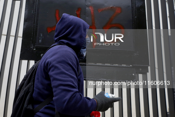 The 43 missing students of Ayotzinapa paint graffiti outside the Senate of the Republic in Mexico City, Mexico, on September 24, 2024, to de...