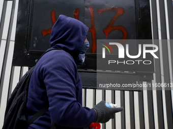 The 43 missing students of Ayotzinapa paint graffiti outside the Senate of the Republic in Mexico City, Mexico, on September 24, 2024, to de...