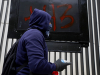 The 43 missing students of Ayotzinapa paint graffiti outside the Senate of the Republic in Mexico City, Mexico, on September 24, 2024, to de...