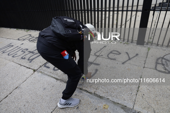 The 43 missing students of Ayotzinapa paint graffiti outside the Senate of the Republic in Mexico City, Mexico, on September 24, 2024, to de...