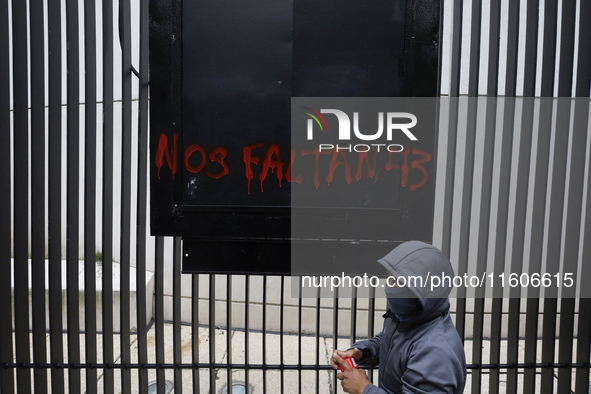 The 43 missing students of Ayotzinapa paint graffiti outside the Senate of the Republic in Mexico City, Mexico, on September 24, 2024, to de...