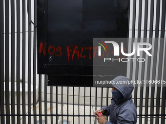 The 43 missing students of Ayotzinapa paint graffiti outside the Senate of the Republic in Mexico City, Mexico, on September 24, 2024, to de...