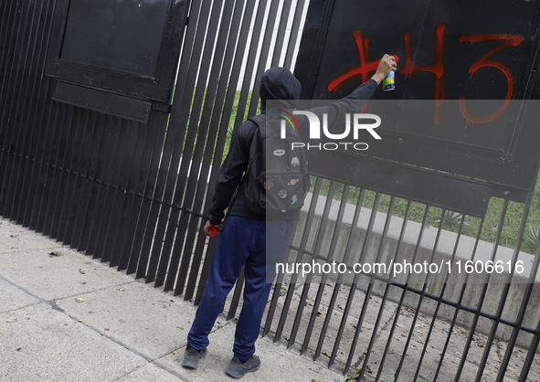 The 43 missing students of Ayotzinapa paint graffiti outside the Senate of the Republic in Mexico City, Mexico, on September 24, 2024, to de...