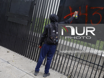 The 43 missing students of Ayotzinapa paint graffiti outside the Senate of the Republic in Mexico City, Mexico, on September 24, 2024, to de...