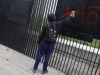 The 43 missing students of Ayotzinapa paint graffiti outside the Senate of the Republic in Mexico City, Mexico, on September 24, 2024, to de...