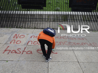 The 43 missing students of Ayotzinapa paint graffiti outside the Senate of the Republic in Mexico City, Mexico, on September 24, 2024, to de...