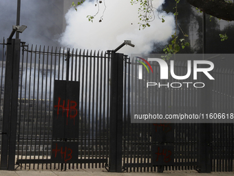 The 43 missing students from Ayotzinapa throw firecrackers at the Senate of the Republic in Mexico City, Mexico, on September 24, 2024, to d...