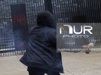 The 43 missing students from Ayotzinapa throw firecrackers at the Senate of the Republic in Mexico City, Mexico, on September 24, 2024, to d...