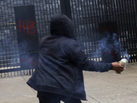 The 43 missing students from Ayotzinapa throw firecrackers at the Senate of the Republic in Mexico City, Mexico, on September 24, 2024, to d...