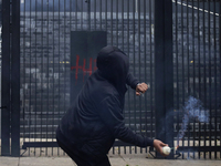 The 43 missing students from Ayotzinapa throw firecrackers at the Senate of the Republic in Mexico City, Mexico, on September 24, 2024, to d...